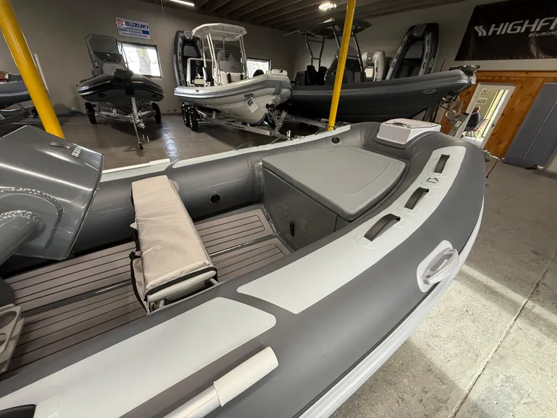 Slide: The Image of 2025 Highfield Classic 380 FCT inflatable boat in showroom, gray and white interior. - 4