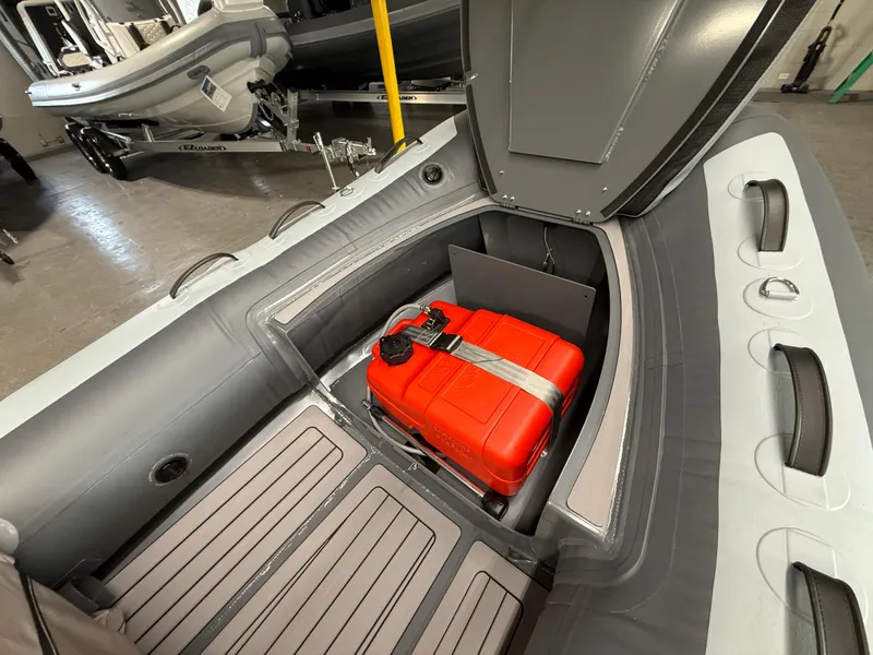Slide: The Image of 2025 Highfield Classic 380 FCT boat with open storage compartment and red fuel tank. - 5