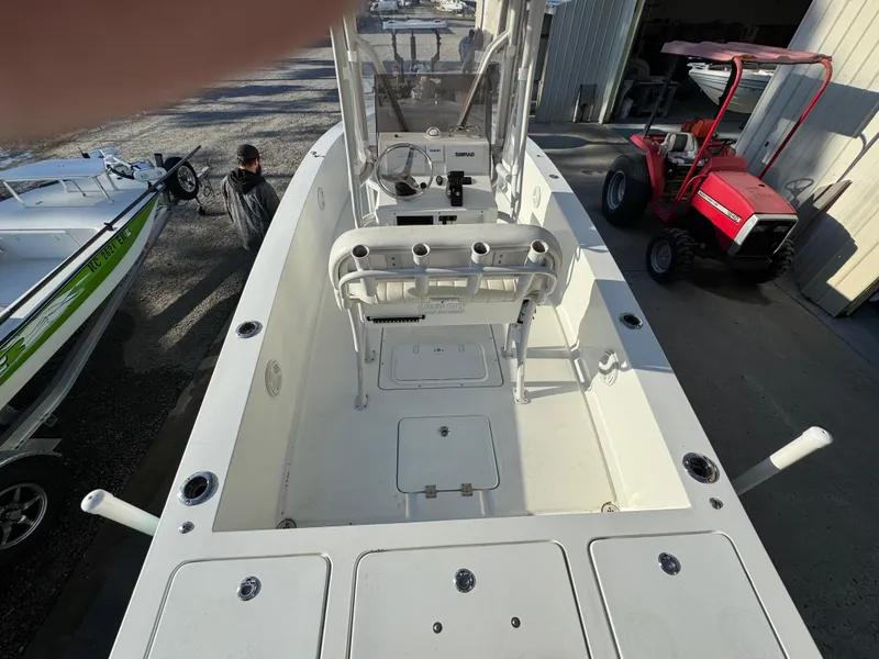 Slide: The Image of 2020 Long Bay 230 Bay boat with T-top and center console in a sunny outdoor setting. - 10