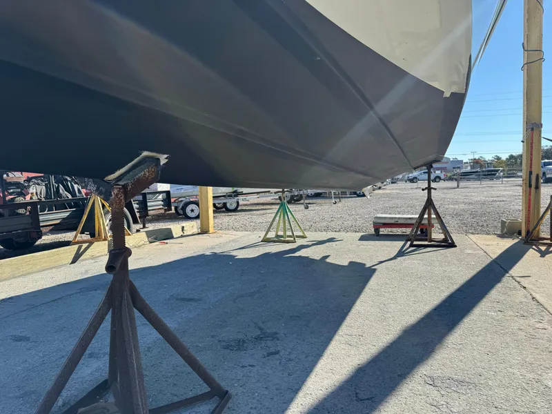 Slide: The Image of 2020 Long Bay 230 Bay boat dashboard with steering wheel, Simrad displays, and controls. - 12