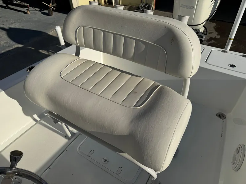 Slide: The Image of 2020 Long Bay 230 Bay boat interior with storage compartment and rearview mirror. - 13
