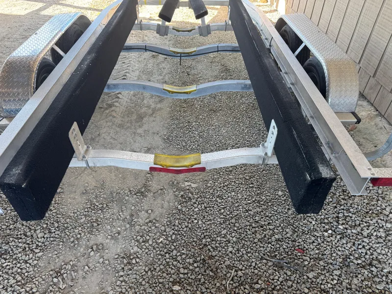 Slide: The Image of 2020 Long Bay 230 Bay boat interior with open storage compartments and cushioned seating. - 26