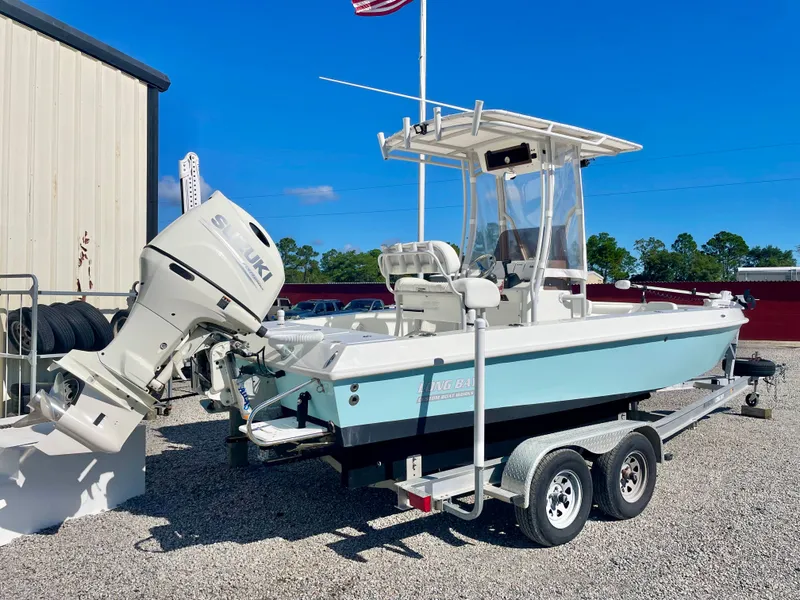 Slide: The Image of 2020 Long Bay 230 Bay boat on trailer with Suzuki outboard motor. - 38