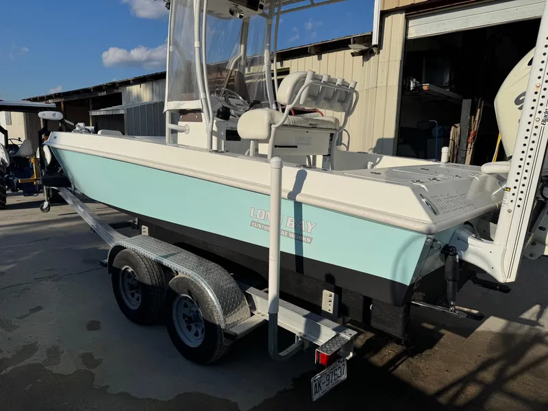 Slide: The Image of 2020 Long Bay 230 Bay boat on trailer under clear blue sky. - 4
