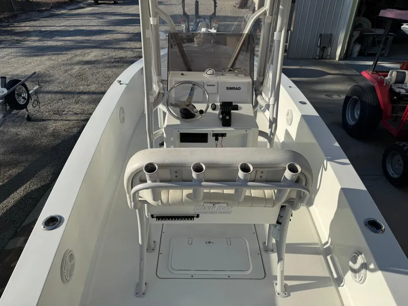 Slide: The Image of 2020 Long Bay 230 Bay boat displayed outdoors at a dealership. - 6