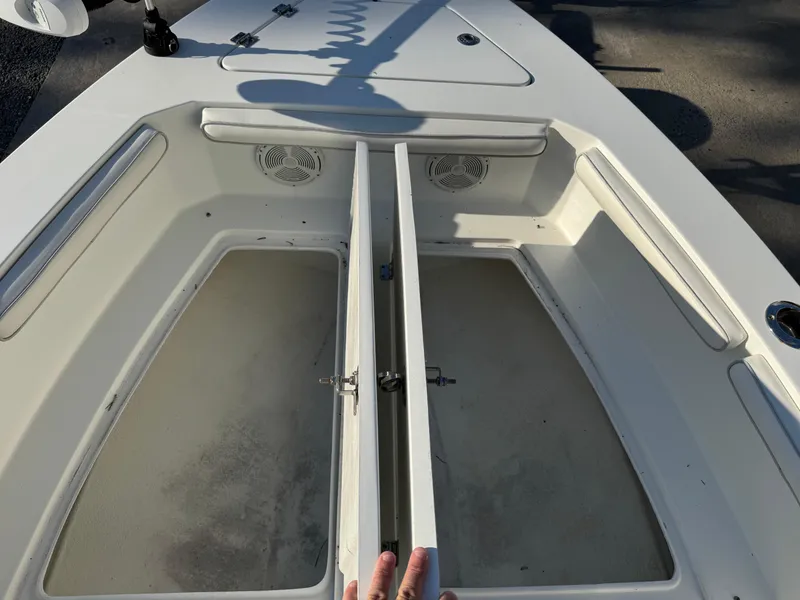 Slide: The Image of 2020 Long Bay 230 Bay boat with Suzuki engine, parked on a trailer in a sunny lot. - 8