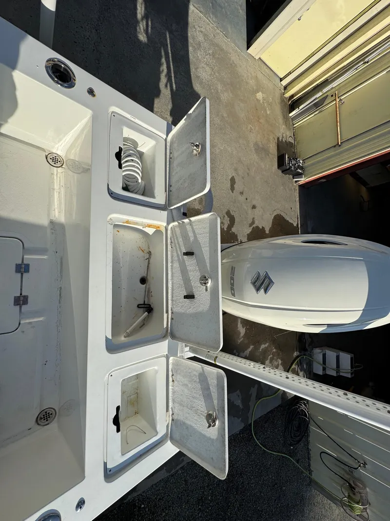 Slide: The Image of 2020 Long Bay 230 Bay boat with Suzuki 200 engine, parked outdoors. - 9