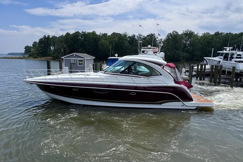 Slide: The Image of 2012 Formula 45 Yacht cruising on a calm lake near a dock. - 1