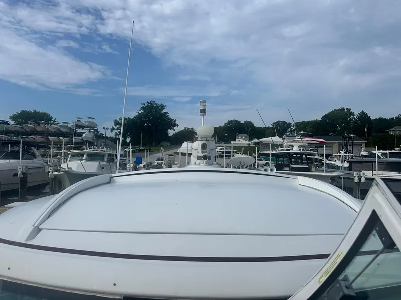 Slide: The Image of 2012 Formula 45 Yacht docked at a marina under a partly cloudy sky. - 11