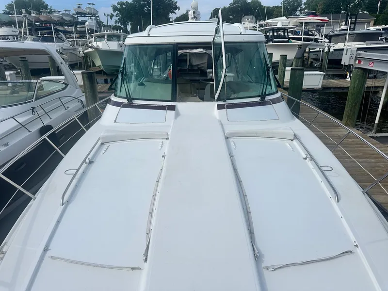 Slide: The Image of 2012 Formula 45 Yacht docked at marina, showcasing sleek design and spacious deck. - 14