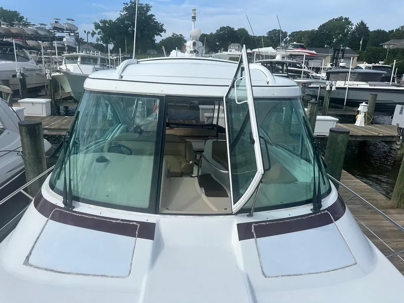 Slide: The Image of 2012 Formula 45 Yacht docked at a marina, showcasing its sleek design and spacious interior. - 15