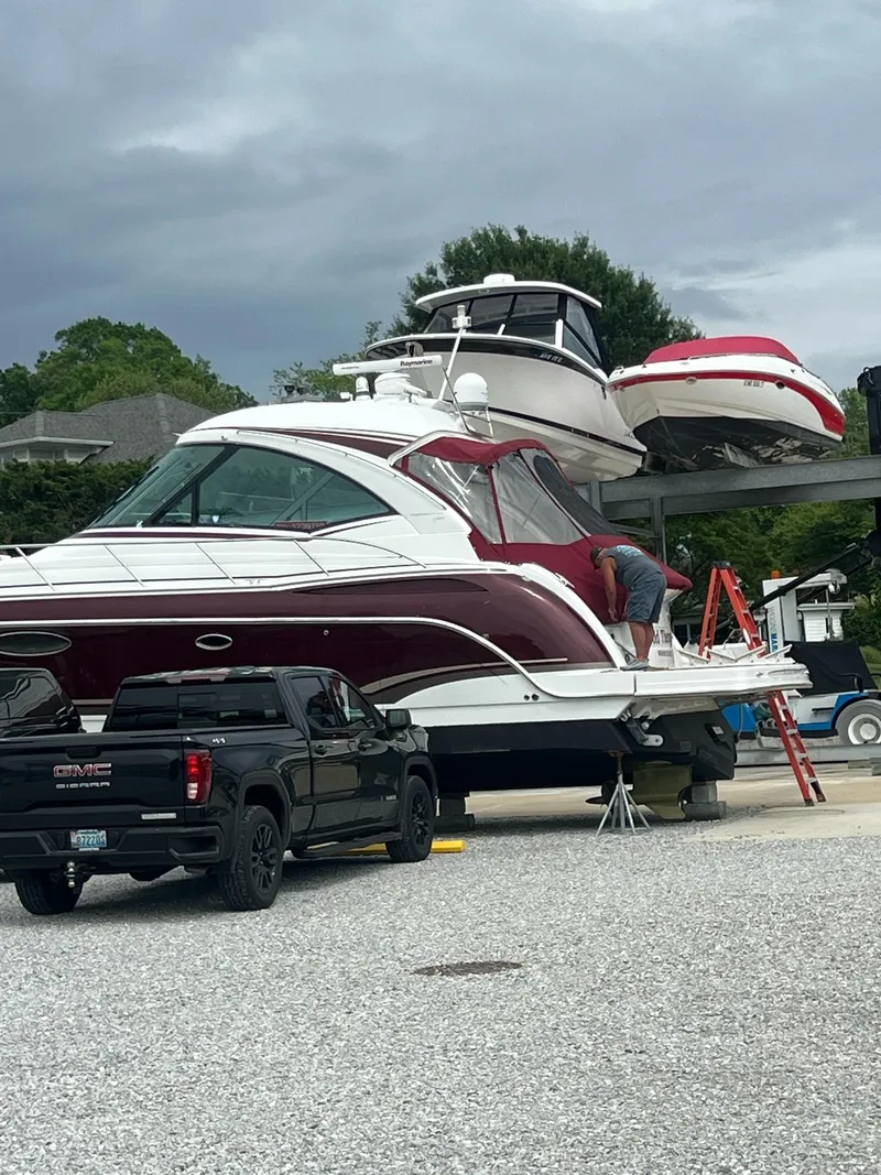 Slide: The Image of 2012 Formula 45 Yacht on trailer with truck, under cloudy sky. - 2