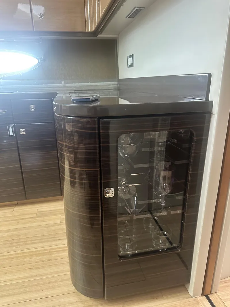 Slide: The Image of Interior of 2012 Formula 45 Yacht featuring a sleek cabinet with glass door. - 48