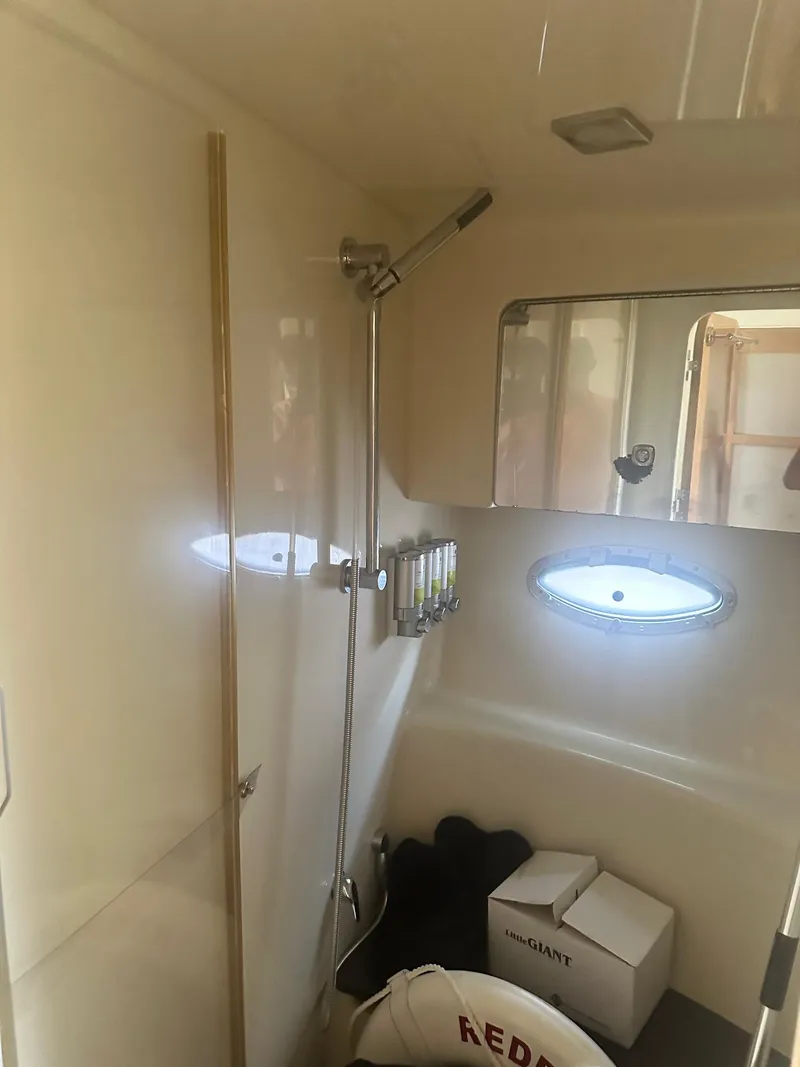 Slide: The Image of 2012 Formula 45 Yacht bathroom with shower, window, and storage space. - 49