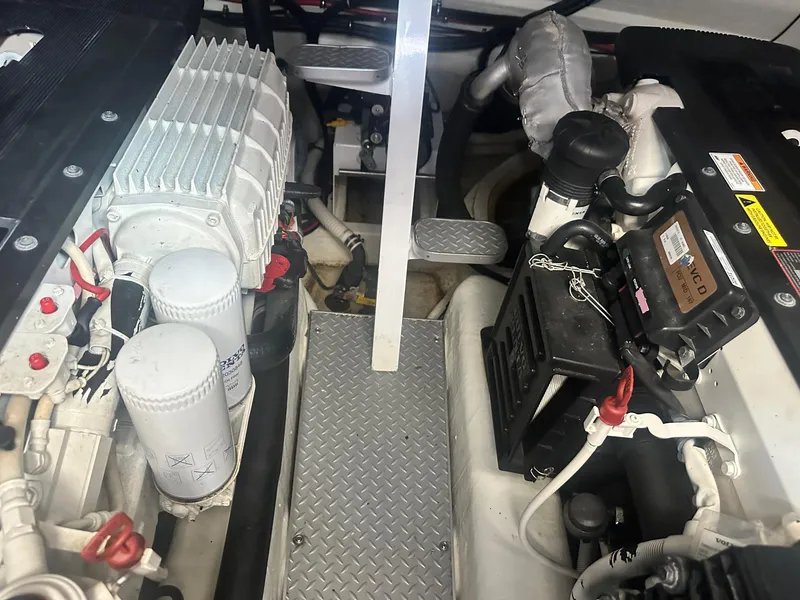 Slide: The Image of Engine compartment of a 2012 Formula 45 Yacht, showcasing mechanical components and filters. - 52