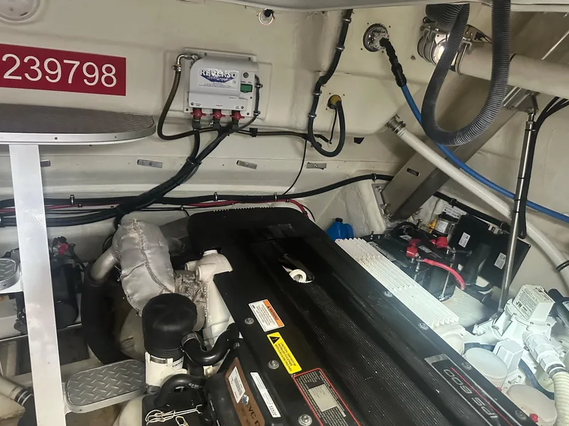 Slide: The Image of Engine room of a 2012 Formula 45 Yacht, showcasing mechanical components and wiring. - 53