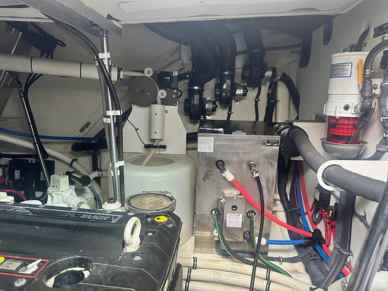 Slide: The Image of Engine room of a 2012 Formula 45 Yacht, showcasing mechanical components and wiring. - 54