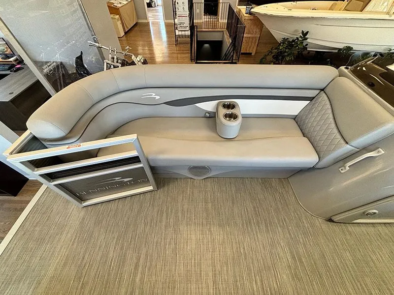 Slide: The Image of 2023 Bennington S 20 Cruise Narrow Beam boat interior with gray seating and cup holders. - 13