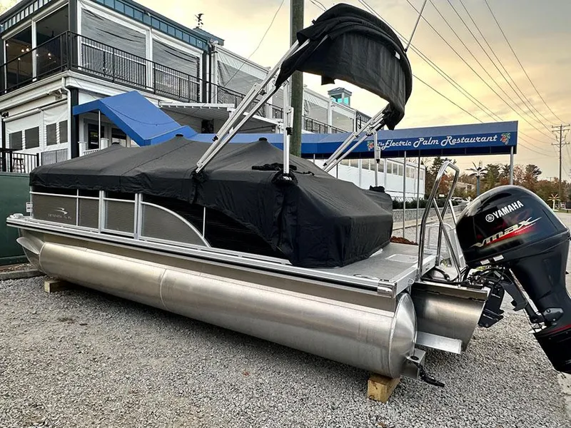 Slide: The Image of 2023 Bennington S 20 Cruise Narrow Beam pontoon boat with Yamaha engine, parked near restaurant. - 15