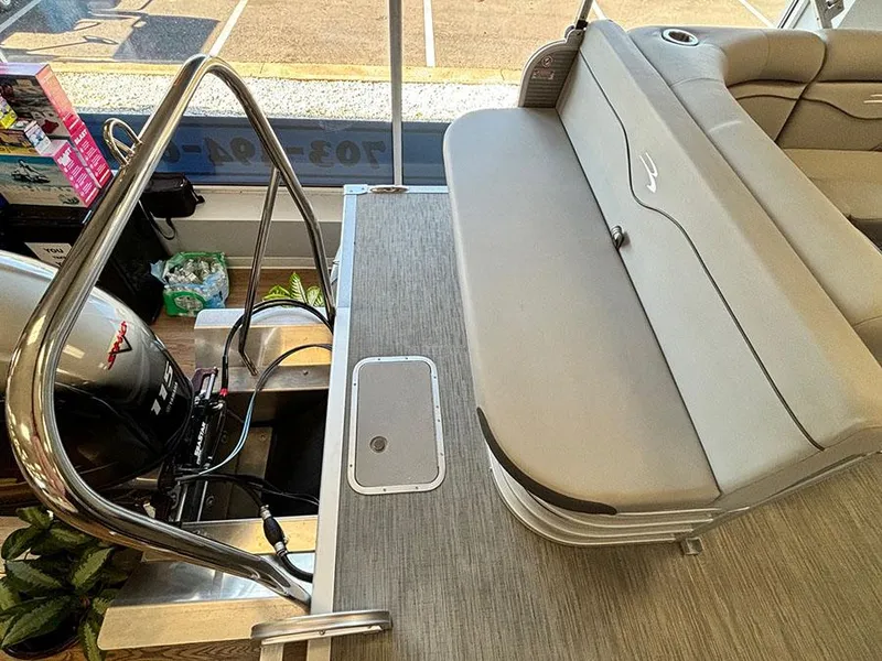 Slide: The Image of 2023 Bennington S 20 Cruise Narrow Beam boat interior with seating and motor. - 5