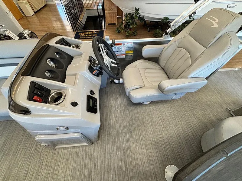 Slide: The Image of 2023 Bennington S 20 Cruise Narrow Beam boat interior with captain's chair and control panel. - 9