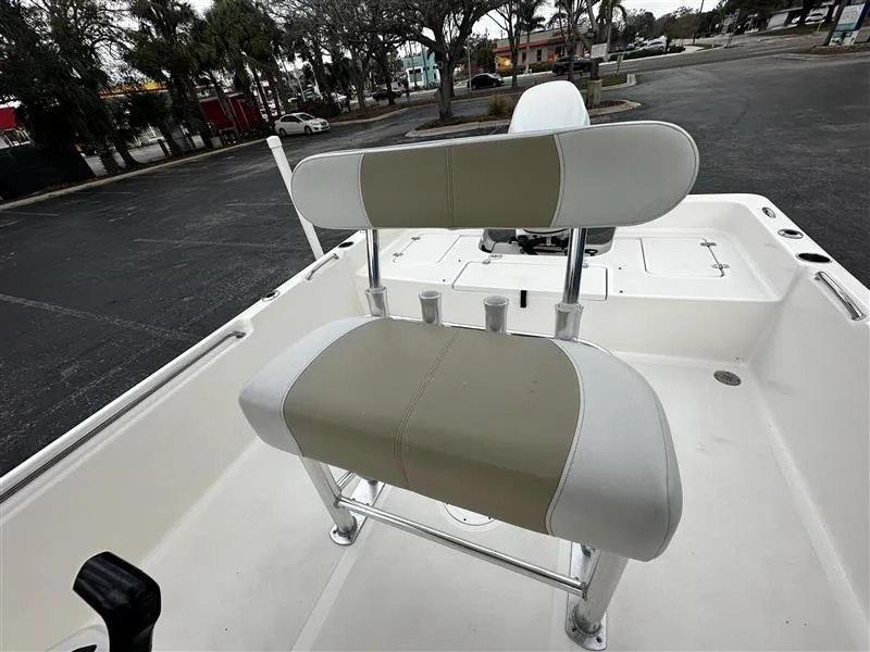 Slide: The Image of 2022 Bulls Bay 2400 boat interior with beige and white seating. - 11