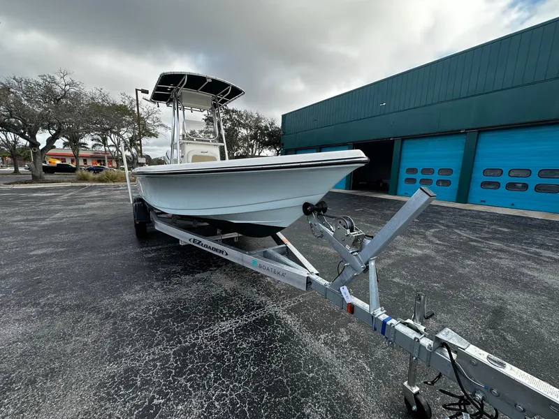 Slide: The Image of 2022 Bulls Bay 2400 boat on trailer, parked outdoors near blue garage doors. - 3