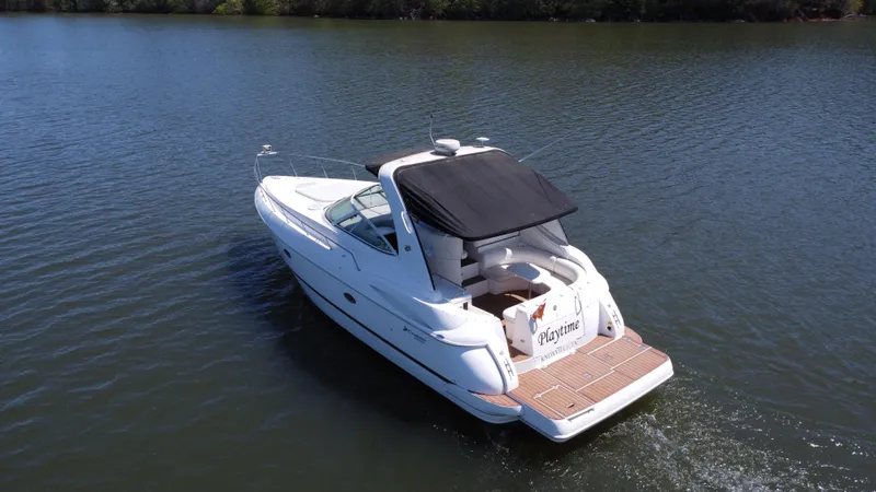 Slide: The Image of 2004 Cruisers Yachts 370 Express on calm water, featuring sleek design and spacious deck. - 8