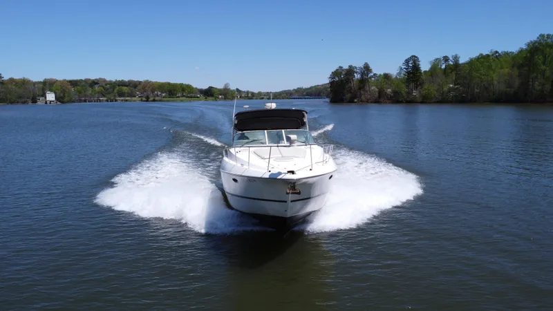 Slide: The Image of 2004 Cruisers Yachts 370 Express cruising on a scenic lake. - 3