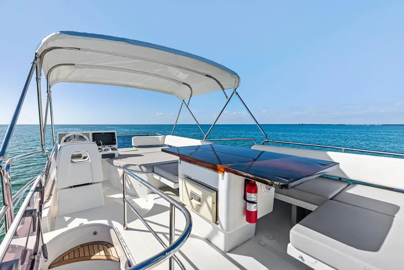 Slide: The Image of Azimut 45 Fly 2014 yacht flybridge with seating, table, and ocean view. - 21