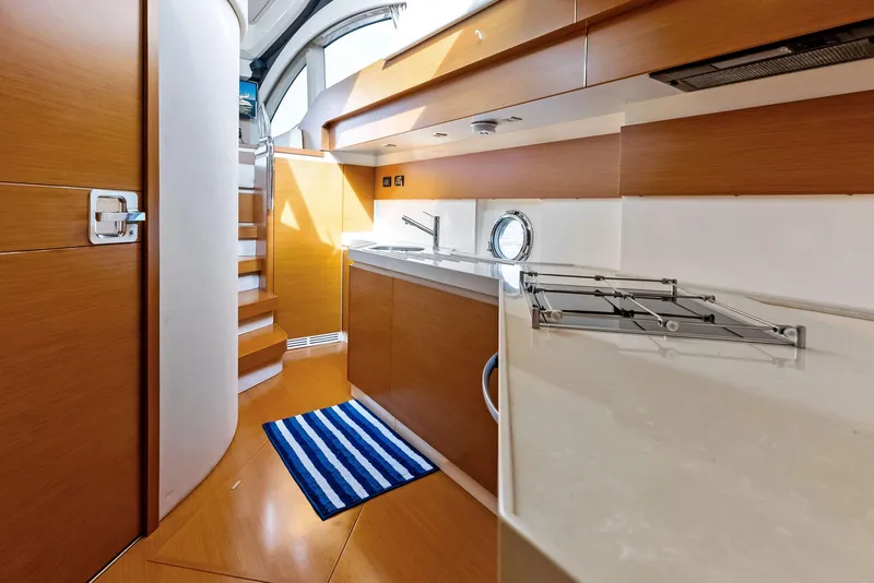 Slide: The Image of Interior of 2014 Azimut 45 Fly yacht, featuring modern kitchen and staircase. - 43