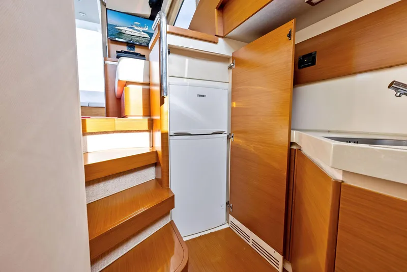 Slide: The Image of Azimut 45 Fly 2014 yacht interior with wooden stairs and kitchen area. - 46