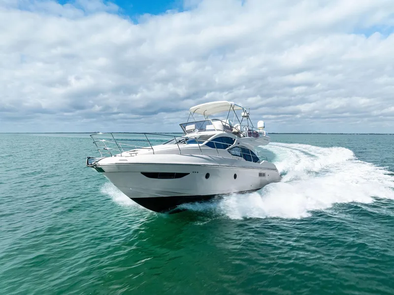 Slide: The Image of 2014 Azimut 45 Fly yacht cruising on open water under a cloudy sky. - 8