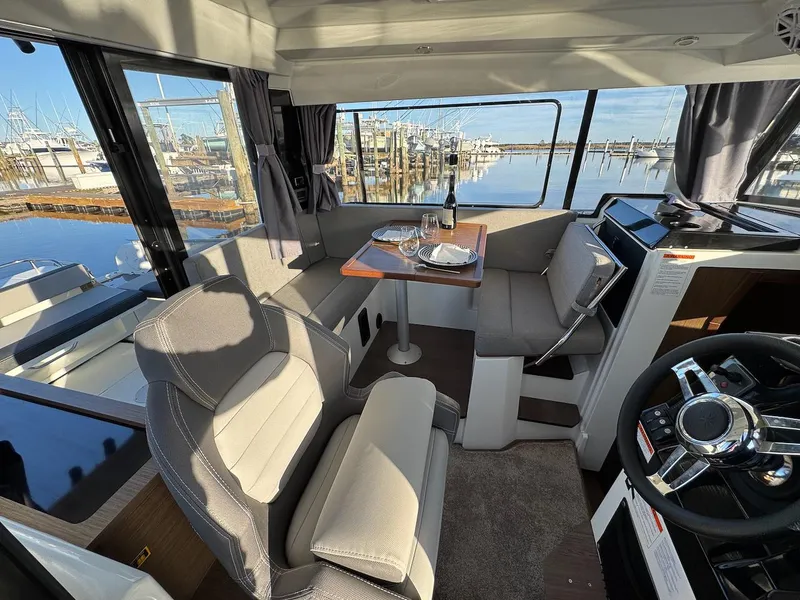 Slide: The Image of Interior of 2020 Jeanneau NC Sport 895 boat with dining area and helm. - 11