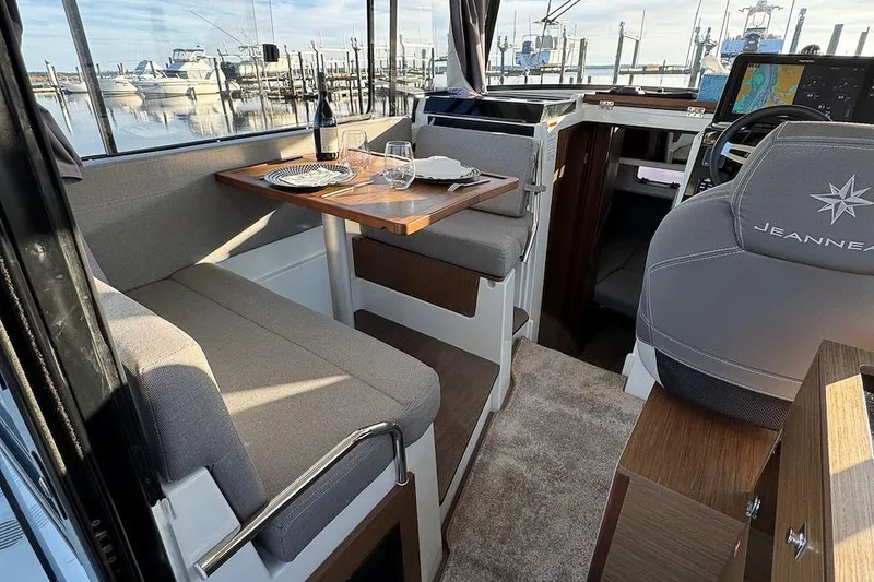Slide: The Image of Interior of 2020 Jeanneau NC Sport 895 boat with dining area and helm. - 12