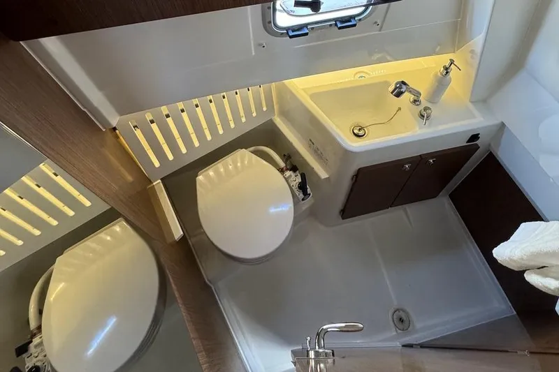 Slide: The Image of 2020 Jeanneau NC Sport 895 bathroom with sink, toilet, and mirror. - 16