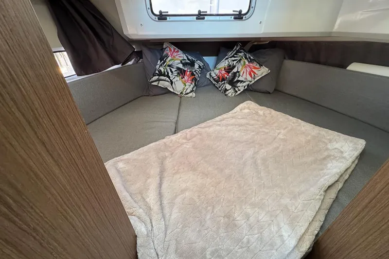 Slide: The Image of Cozy cabin interior of 2020 Jeanneau NC Sport 895 with cushions and blanket. - 17