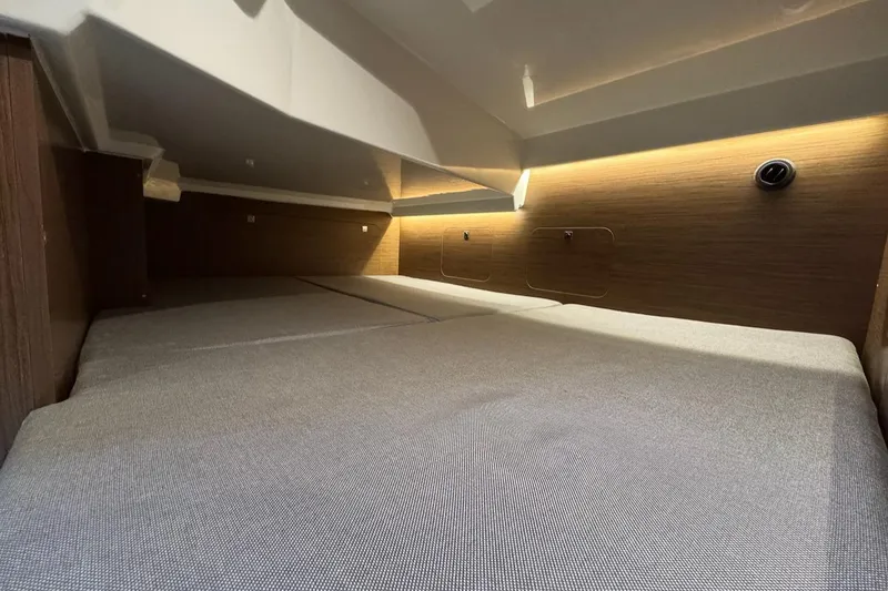 Slide: The Image of Interior cabin of 2020 Jeanneau NC Sport 895 with modern lighting and cozy bedding. - 19