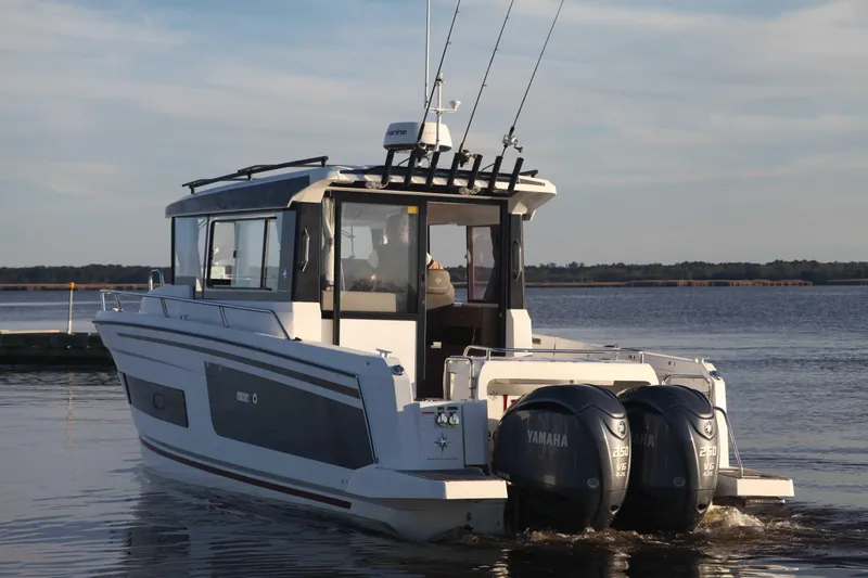 Slide: The Image of 2020 Jeanneau NC Sport 895 boat with dual Yamaha engines on a calm lake. - 3