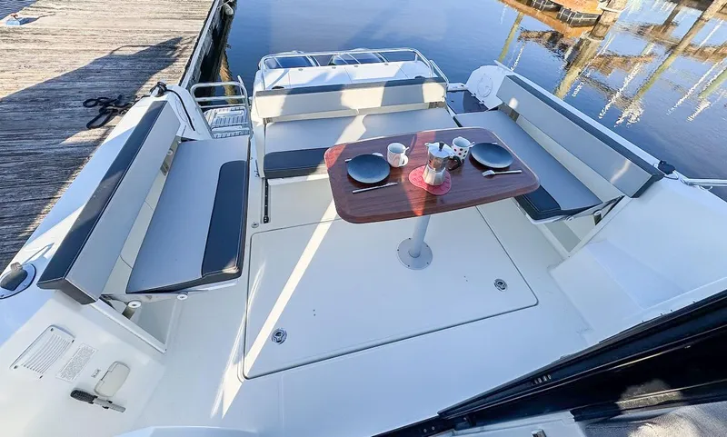 Slide: The Image of 2020 Jeanneau NC Sport 895 boat deck with seating and dining table. - 7