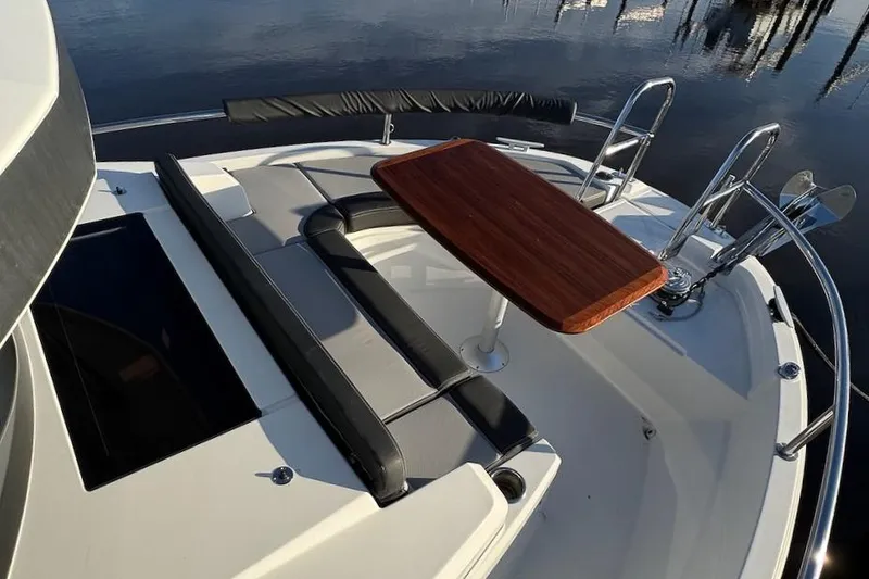 Slide: The Image of 2020 Jeanneau NC Sport 895 boat deck with seating and wooden table. - 9