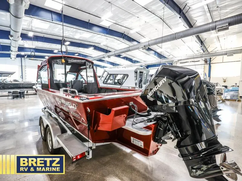 Slide: The Image of 2025 Stryker X220 boat with Mercury engine in showroom. - 3