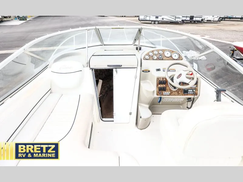 Slide: The Image of Interior view of 2000 Bayliner 2455 boat cockpit with steering wheel and seating. - 10