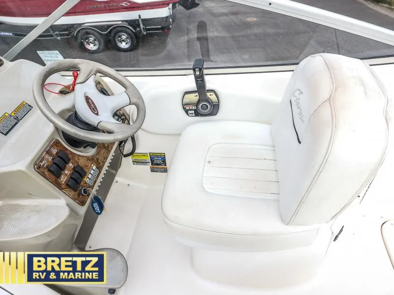 Slide: The Image of Bayliner 2455 boat cockpit with steering wheel and control panel, 2000 model. - 12