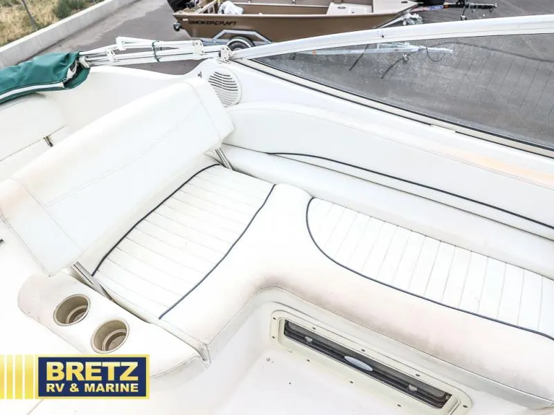 Slide: The Image of Interior seating of a 2000 Bayliner 2455 boat with white upholstery. - 17