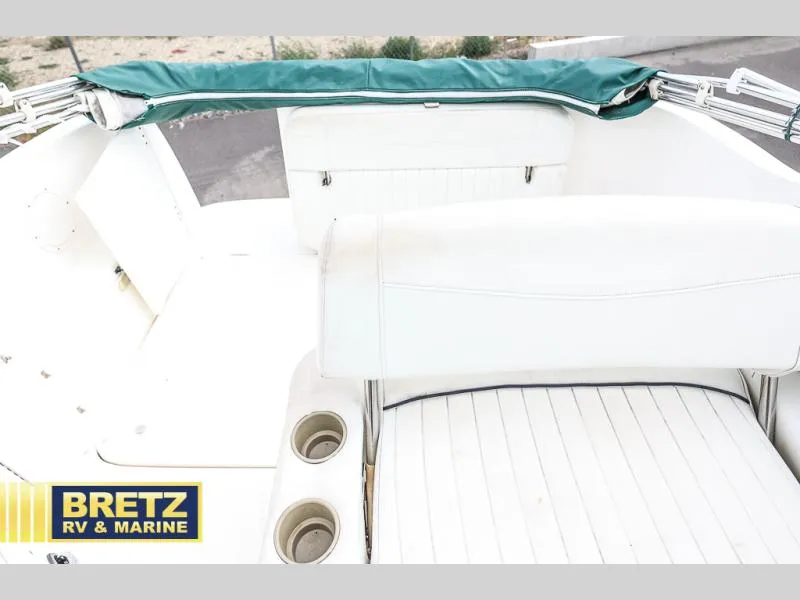 Slide: The Image of Interior view of 2000 Bayliner 2455 boat with white seating and cup holders. - 18