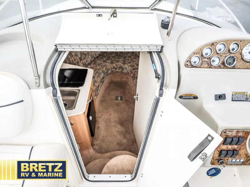 Slide: The Image of Interior view of 2000 Bayliner 2455 boat cabin with kitchenette and control panel. - 20