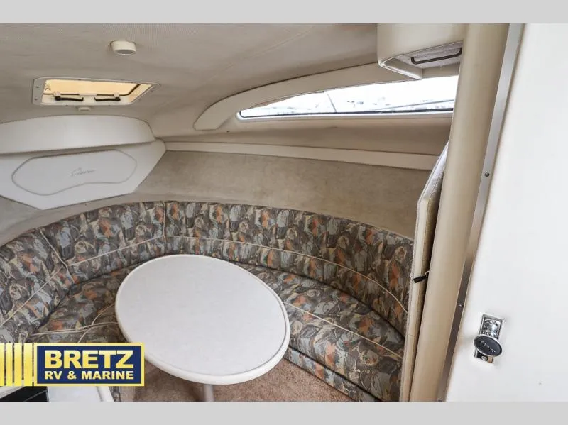 Slide: The Image of Interior of 2000 Bayliner 2455 boat with round table and patterned seating. - 22