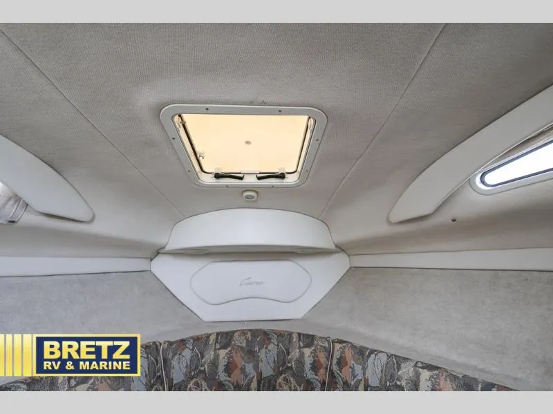 Slide: The Image of Interior cabin of 2000 Bayliner 2455 boat with ceiling hatch and patterned upholstery. - 23