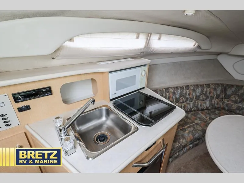 Slide: The Image of Interior of 2000 Bayliner 2455 boat with kitchenette and seating area. - 24